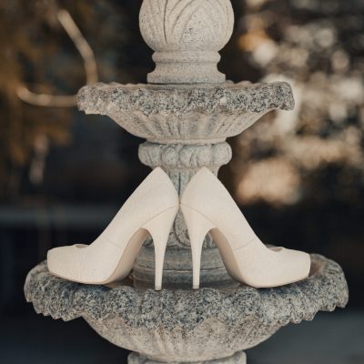 Wedding shoes on a green background. Fountain.